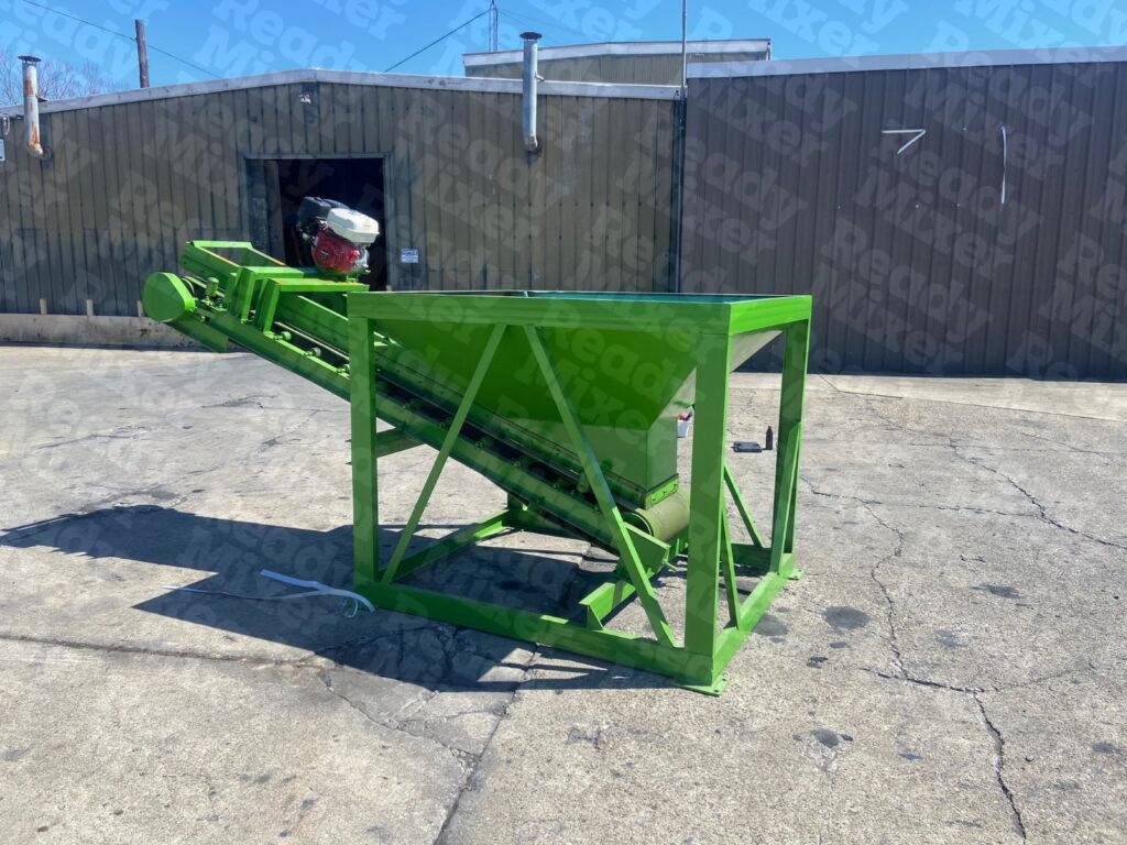 Angled conveyor system with green hopper featuring powered belt drive and Honda engine