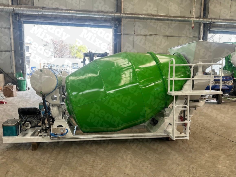 Green Ready Mixer concrete mixer with white fuel tank and loading hopper mounted on skid rail frame