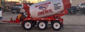 Red and white Superior Concrete Ready Mixer truck with 3-yard capacity and water attachment